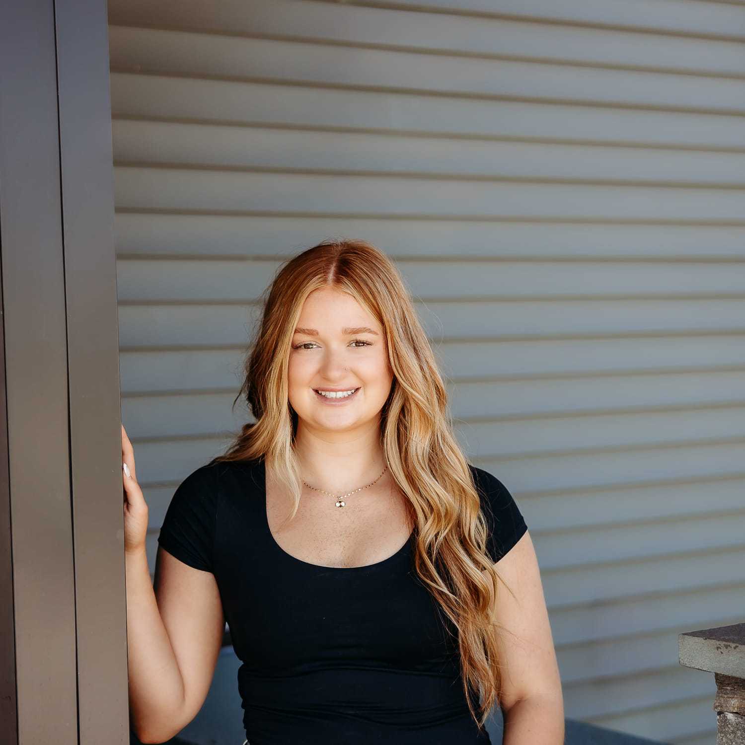 Portrait of Faith R., a professional stylist at Revive Salon & Spa, showcasing their expertise and style.